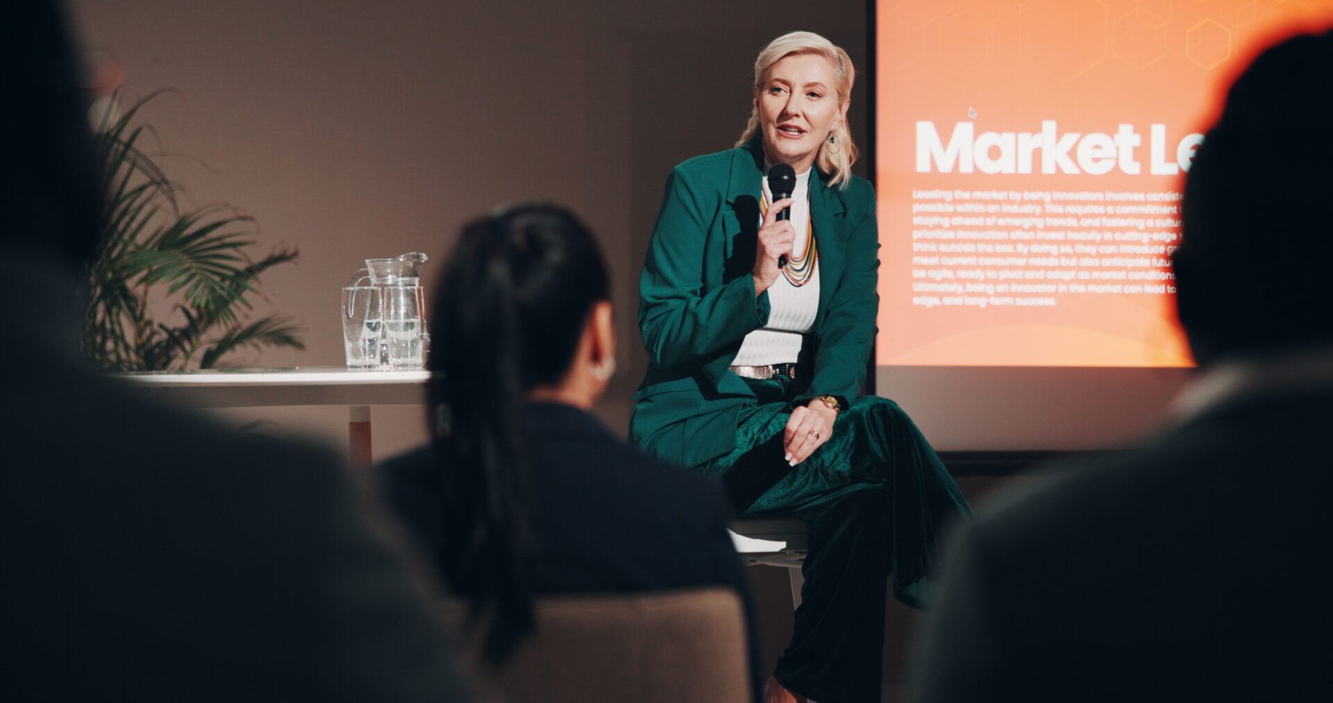 Mature woman, stage and seminar with microphone for leadership skills, information or knowledge. Fe.