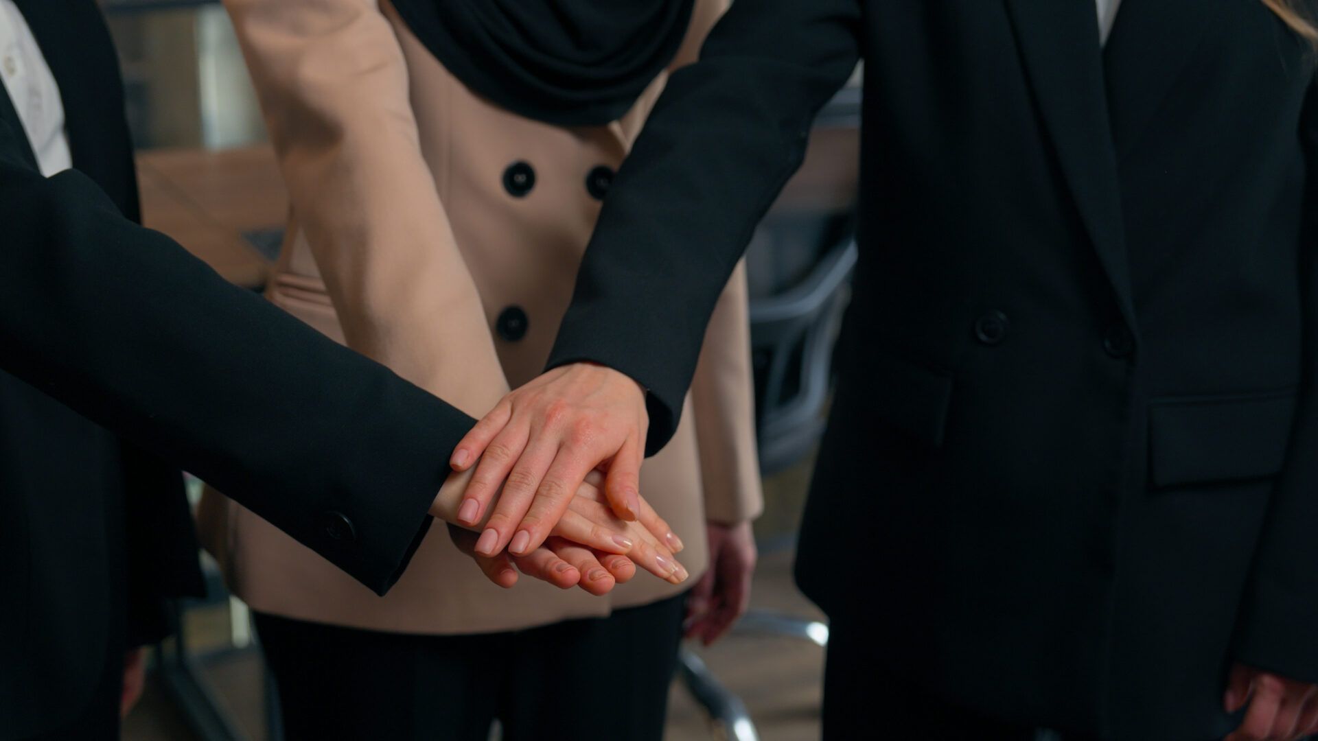 Multiracial women business colleagues three multiethnic businesswomen girls Caucasian Asian Muslim ladies ethnic different unite happy office team stack female hands together partnership collaboration. High quality 4k footage